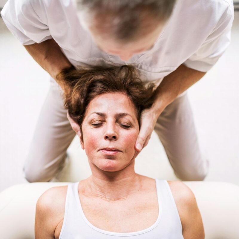 Chiropractor adjusting patient spine to improve mobility and alleviate joint discomfort