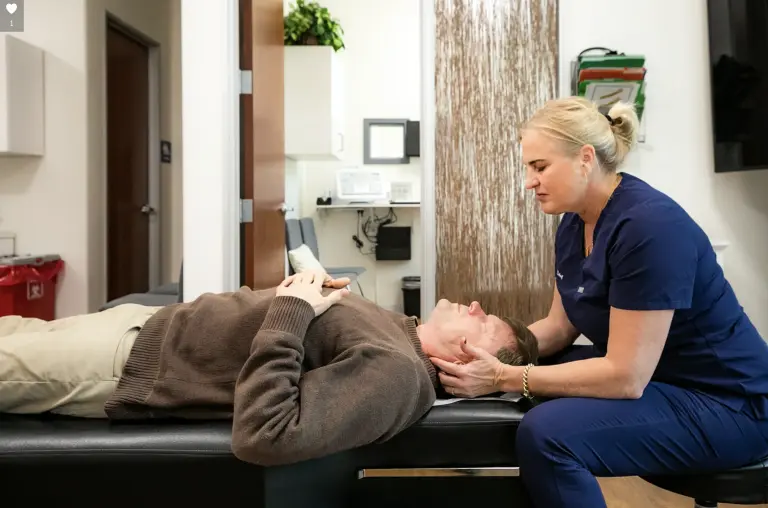Chiropractor performing a gentle neck treatment on a patient at Marin Joint Health